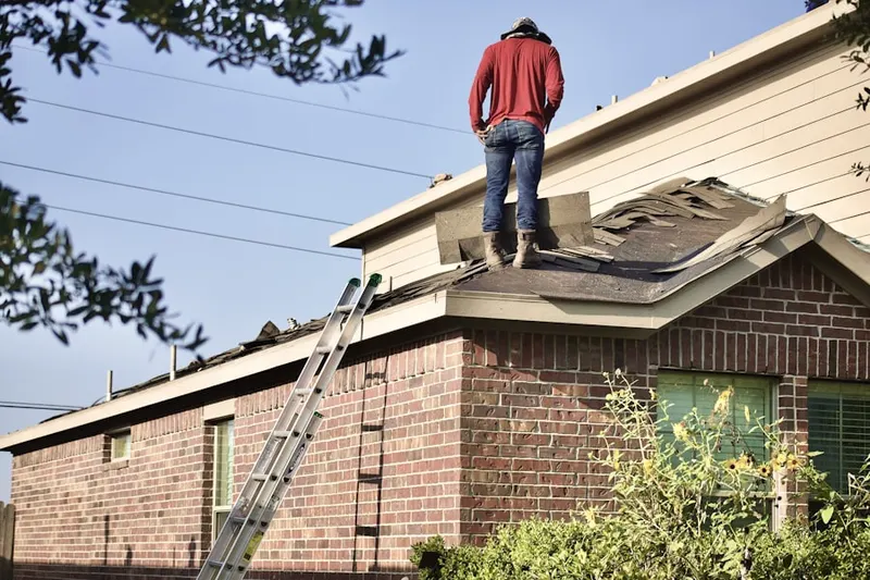 Professional roofer working on a residential roof in Enterprise